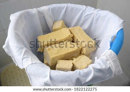 Freshly handmade natural soap put to dry in a bucket covered with fabrics Royalty-Free Stock Photo #1822122275