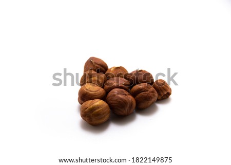 Beautiful hazelnuts collected in a shape on a white isolated background macro photo