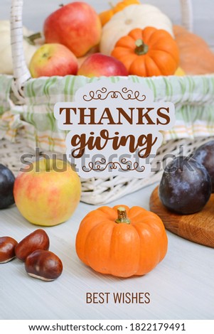 Thanksgiving congratulations with harvest, apples, pumpkins, plums,  wooden background and a handwritten inscription