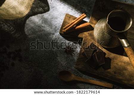 ingredients for making coffee, cinnamon, chocolate, spices on a brown wooden board 1