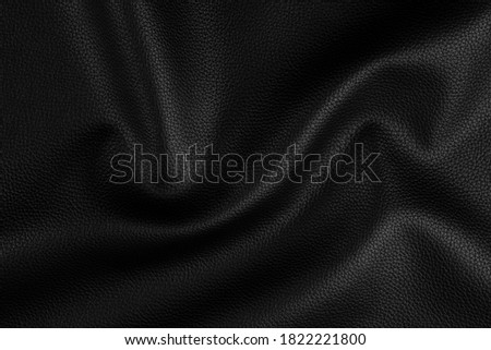 bright natural real black leather with ruckled waves background texture abstract close up, perfect surface studio photography.