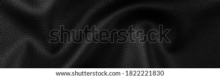 bright natural real black leather with Flexes dark background texture abstract close up, panoramic horizontal surface studio perfect photography.