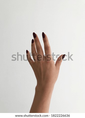 Left hand with manicure on white background