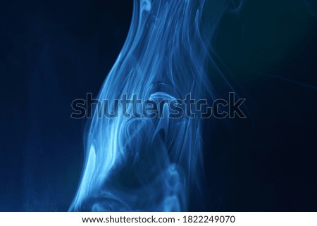 A blue heavy smoke in the darkness - a cool background