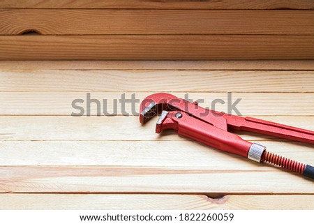 plumbing tools and accessories for adjusting pipe leak. wooden desk background. plumber service concept. fixing house problems.