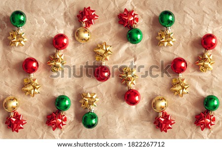 Christmas minimal pattern - colored xmas ball on brown background. Flat lay, top view.