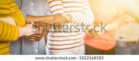 Creative team meeting hands together in line. Young business people are holding hands. Unity and teamwork concept.  Royalty-Free Stock Photo #1822268582