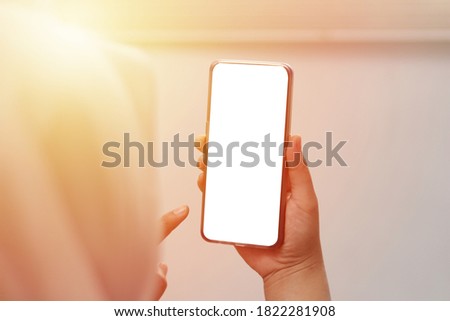 Close up image of smart phone mockup, woman holding phone with white screen template