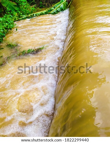 Water flood after heavy rain in odisha, india . Brown color water flowing