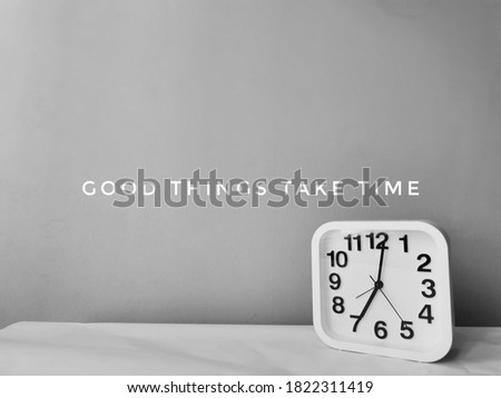 Square shape clock and phrase Good things take time,banner design.Image may contain noise or grain due to low light.Selective focus.
