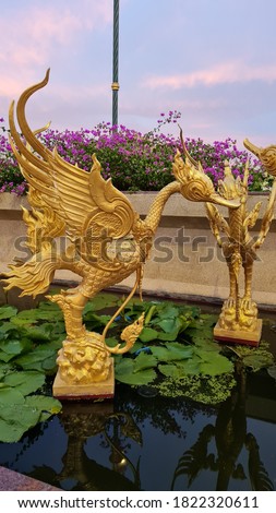 Thai golden swan statue. Golden swan cement statue in Thai style.