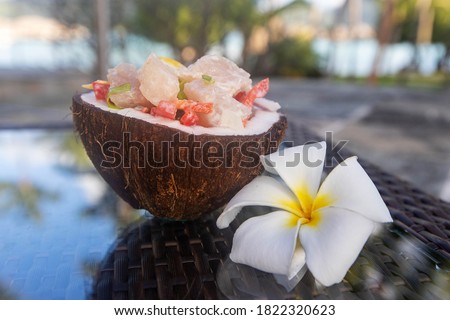 Fresh Poission Cru (raw fish) in a coconut shell.  Royalty-Free Stock Photo #1822320623
