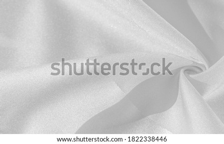 Silk is white. White gray satin texture, it is silver fabric, silk panorama, background with beautiful soft blur pattern. Texture, background pattern