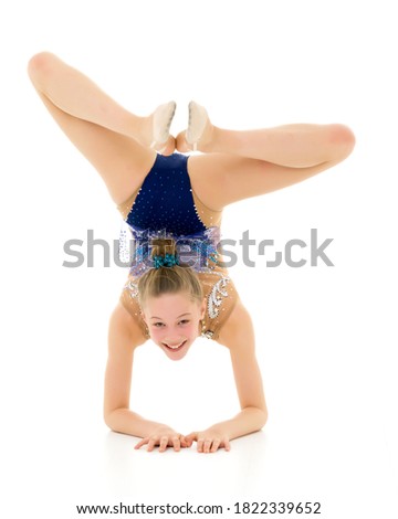 A gymnast performs an exercise stance on her forearms.