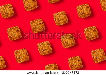 translation of the Chinese to English-five kernels-top view traditional mooncake on red lined up no logo or trademark