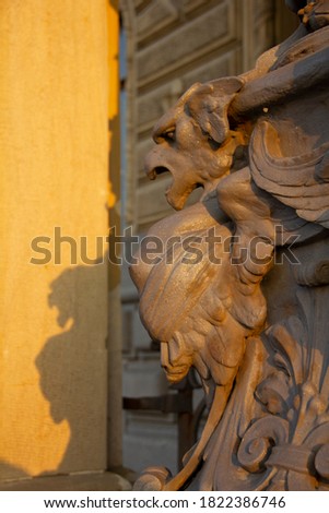 Architectural detail. Forged metal decorative architectural decoration, close-up. fantastic animal. Sunset. Beautiful lighting. light and shadow