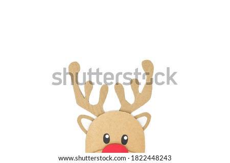 Cute and happy baby reindeer cardboard cutout icon with red nose peeking on a white background. Christmas is coming and hello december concept.