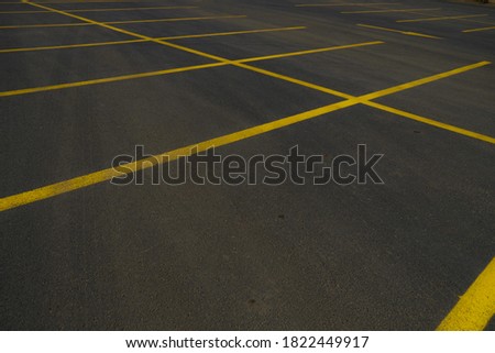 yellow lines in the big black asphalt international way, asphalt parking area, car park 
