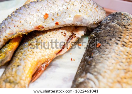 Raw fish with spices cooking on the table. Seafood concept