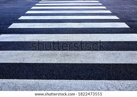 Zebra crossing, white stripes on 
 asphalt pedestrian, go straight on crosswalk for across the road safely. 