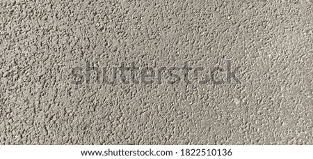 Grainy gray asphalt on a Sunny day