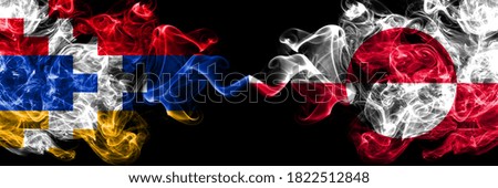 Nagorno-Karabakh, Artsakh vs Greenland smoky mystic flags placed side by side. Thick colored silky abstract smoke flags