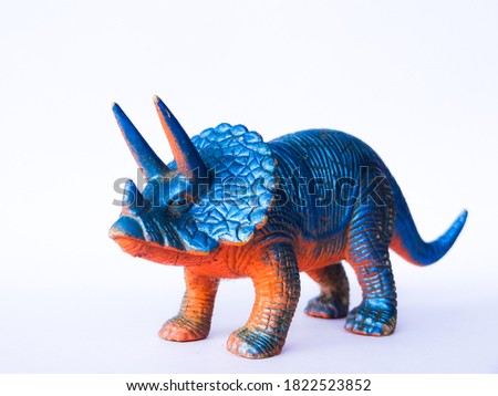 blue dinosaur toy on white background