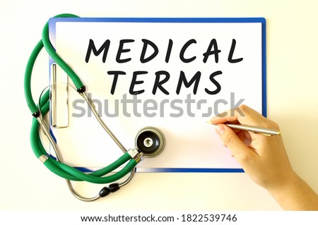 Female doctor's hand makes an inscription in a document. Medical concept.