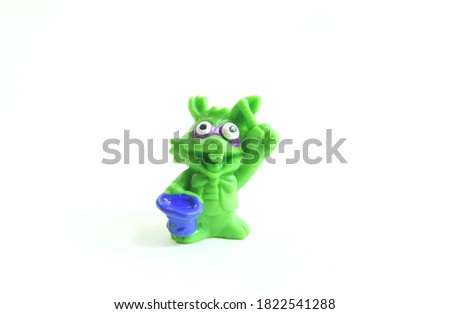 rubber kids toy smiling green rabbit isolated on white background