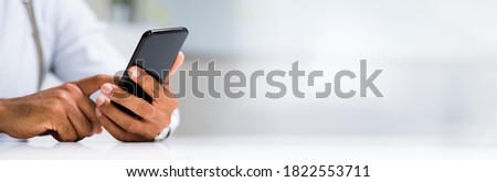 African Man Holding Smartphone Or Mobile Phone