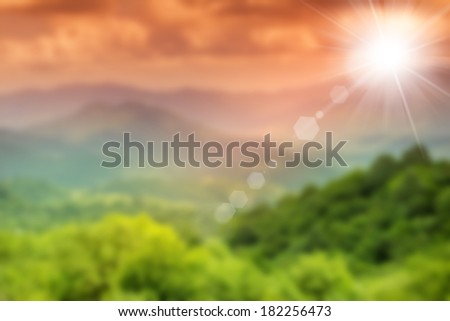 blurred picture of green field and sunset sky, summer background