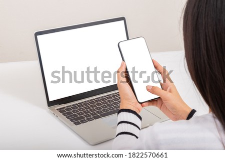 Online Shopping Concept. Women use smartphone with credit card to payment after shopping from laptop