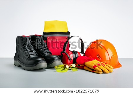 Industrial protective wear-protective shoes, safety glasses, gloves and hearing protection. Royalty-Free Stock Photo #1822571879