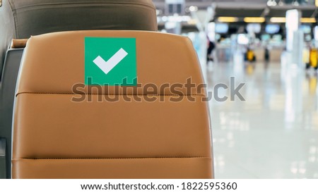 Social distancing, Rows of empty chairs in an airport's departure area marked with symbols regarding social distancing protocol to prevent the spreading of novel corona virus, COVID-19 in Thailand