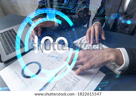 Two business people working together on white paper to release ICO project on market. Try to analyze statistics and optimize transactions processing. Initial coin offer hologram. Double exposure.