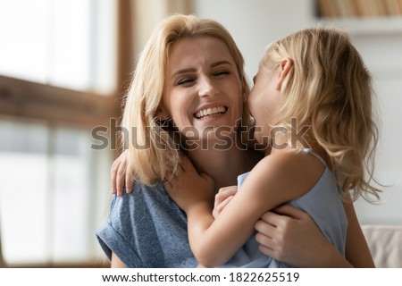 I love you so much, mommy! Cute little daughter embracing happy smiling adult mother, preschooler girl hugging young laughing nanny with affection, foster mom and adopted kid are bound to each other Royalty-Free Stock Photo #1822625519