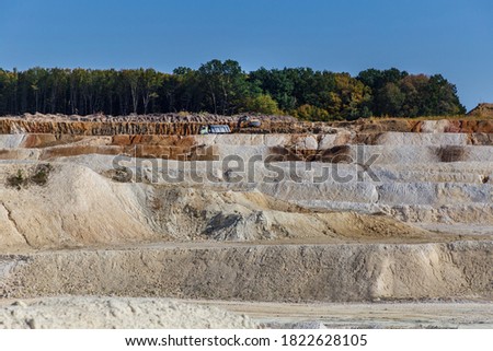 Abandoned granite and sand quarry with a lake. Stone extraction in the canyon.