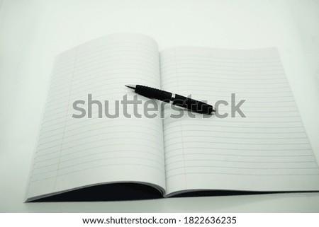 notepad and pen und white background