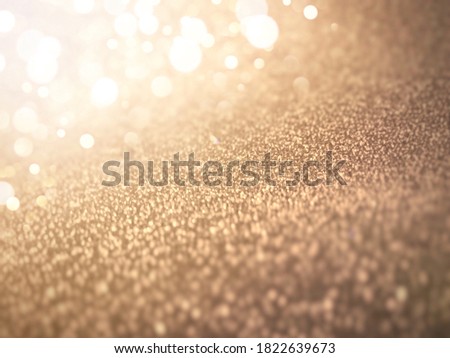 White Bokeh Light on Gold Texture Abstract Background.