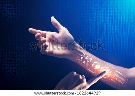 Unrecognizable Man Programming Himself Pressing Key On Virtual Panel Built-In In His Hand On Blue Digital Background. Futuristic Hi-Tech Innovations And Human Future. Closeup, Collage