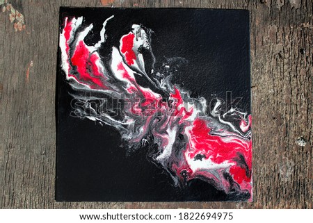 Abstract acrylic painting flame in the dark on an old wooden background. The picture is made using acrylic filling technique.