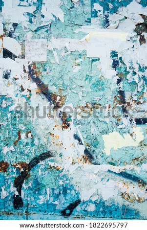 Vertical blue background. grunge rusty texture board with leftover paper ad posters. layering of time. Stylish artistic background textured lines and  scratches. layer posters and banners advertising