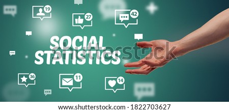 Close-Up of cropped hand pointing at SOCIAL STATISTICS inscription, social networking concept