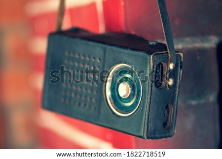 Old vintage retro radio in a black leather case