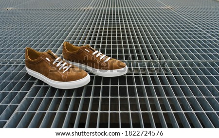 Brown men's shoes with metal background