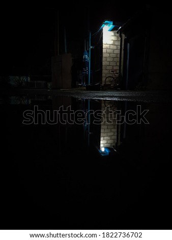 Puddle in the rain, night city background weather. Water reflection lights, night city. Fate night. Night reflection in a puddle