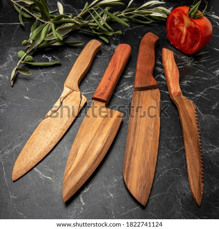 handmade wooden knives on black marble