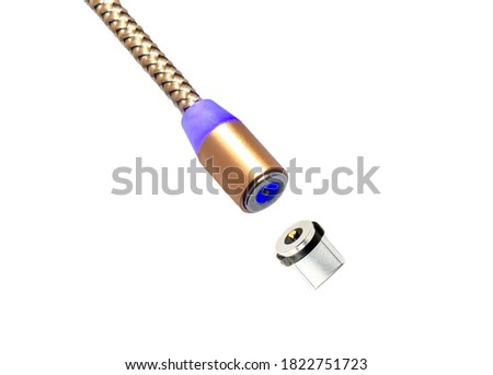 Gold color magnetic charger wire for phone on white background