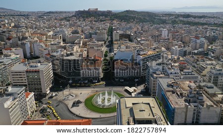 Aerial drone photo of recently renovated Omonoia square featuring huge round fountain and Acropolis hill at the background, Athens centre, Attica, Greece