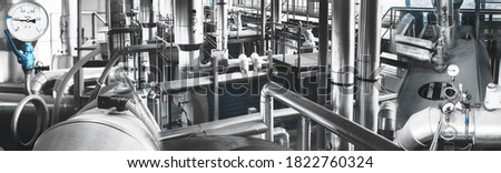 Modern industrial gas boiler room equiped for heating process with heating gas boilers, pipe lines, valves. Panoramic view, composed mixed media. Blue toning. Royalty-Free Stock Photo #1822760324